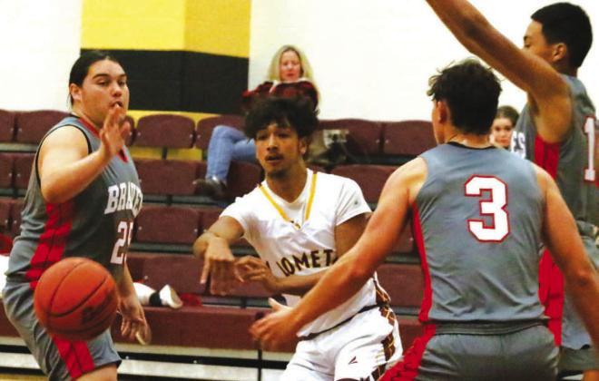 Leonel Caso threads the needle with a pass between three defenders in Lometa’s 71-37 win. MASON HINES | DISPATCH RECORD