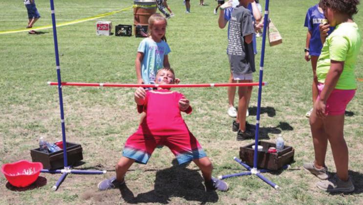Augustus Rhime dominated the limbo events during Kids’ Day at the Gavin Garrett Soccer Field. CHRIS MILES | DISPATCH RECORD