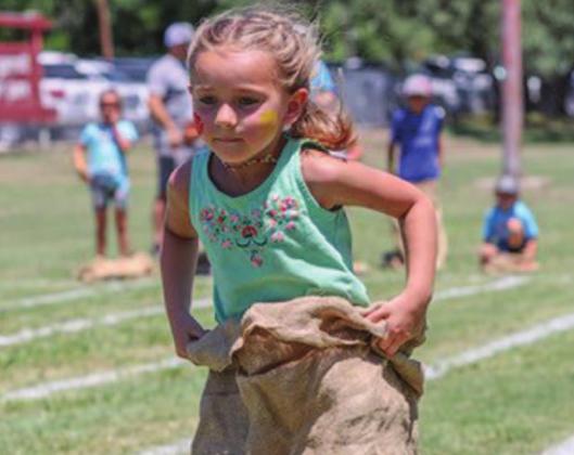 Mili Argo participates in the sack race competition at Kids’ Day. CHRIS MILES | DISPATCH RECORD