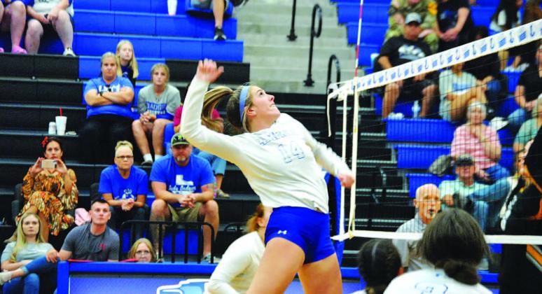 Avery Bolm jumps for a spike in a game at home earlier this season. HUNTER KING | DISPATCH RECORD