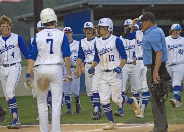 Ace Whitehead (10) crosses the plate on his two-run home run. Teammates celebrating the play include Gauge Gholson (4), Nate Borchardt (7), Carson Bekker (3), Elijah Stanley (next to Whitehead), Tak Stinnett (8) and Hayden Waldrip (42). JEFF LOWE | DISPATCH RECORD