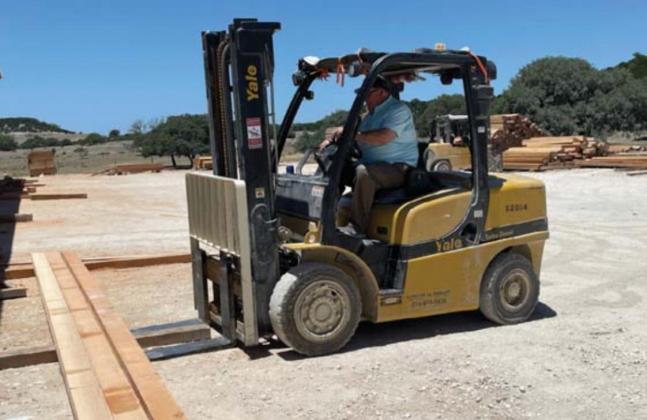 Herb Pearce loads lumber at his BHR Timber facility. He is one of a group of local builders who will provide mentorship this fall for students in a construction science course at the high school. MASON HINES | DISPATCH RECORD