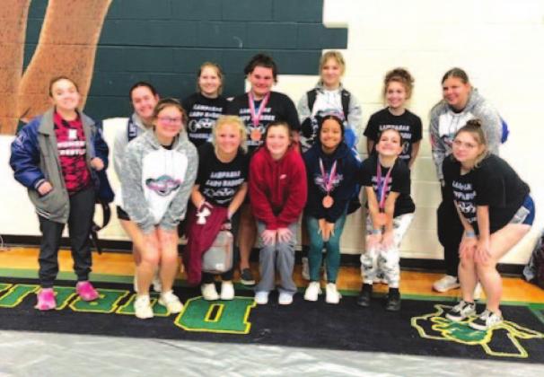 The Lady Badger powerlifting team poses with its medals after finishing in the top half of teams in the region. COURTESY PHOTO