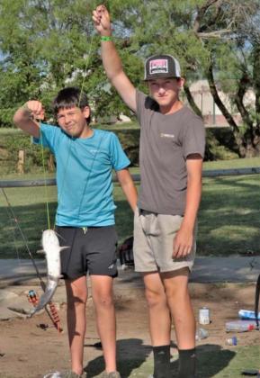 From the left, Mason Miller and Alex Miller hold one of the more than 20 catfish they caught. CHRIS MILES | DISPATCH RECORD Miller hold one of