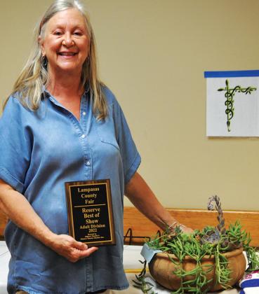 Amanda Hensley poses with her plant and award as reserve best of show in the adult division in Horticulture. MASON HINES | DISPATCH RECORD
