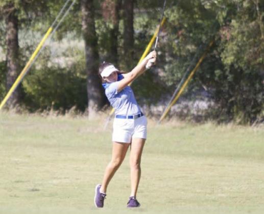 Paige Rutland finishes on a shot from the fairway on hole 5 at Hancock Park Golf Course. HUNTER KING | DISPATCH RECORD