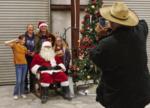 Lometa families had the opportunity to pose with Santa Claus for a photo at the annual Lometa Hometown Christmas Celebration on Saturday evening. ADAM BARRIOS | DISPATCH RECORD