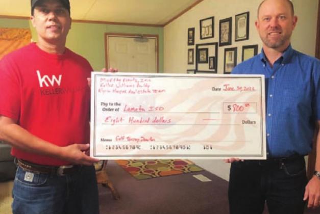 Kenneth Murray, left, hands a check to Lometa ISD Superintendent Rob Moore. COURTESY PHOTO