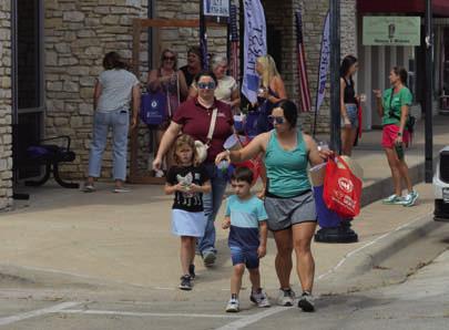 Sip ’N’ Shop customers enjoyed strolling the downtown square during Tuesday’s event. ERICK MITCHELL | DISPATCH RECORD