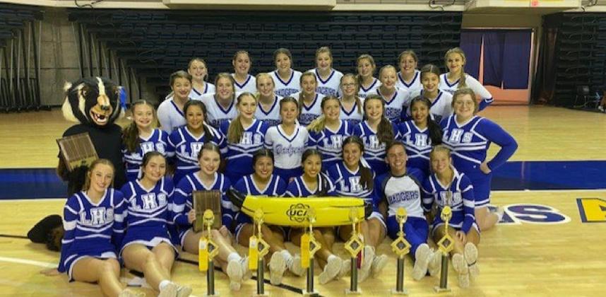 The Lampasas High School varsity and junior varsity cheer teams pose with their trophies at the Universal Cheerleaders Association camp at San Angelo State last month. COURTESY PHOTO