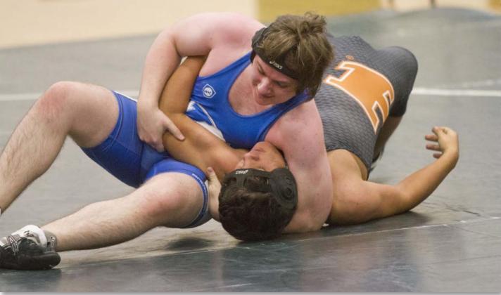 Badger wrestler Jonathan Dill, left, won by default against Hutto on Wednesday after the Hippo locked hands. JEFF LOWE | DISPATCH RECORD