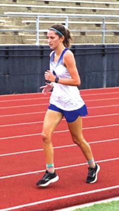Nyla Long rounds the corner during her 3200-meter run. COURTESY PHOTO