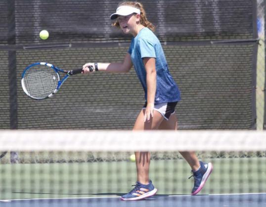 Abby Valdez prepares to hit a return shot during last week’s tennis practice. HUNTER KING | DISPATCH RECORD