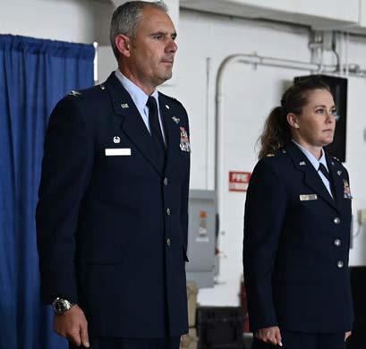 MASTER SGT. BARBARA OLNEY | U.S. AIR NATIONAL GUARD U.S. Air Force Lt. Col. Angi Daiuto, right, and Col. William McCrink III, commander of the 174th Attack Wing, stand at attention during her promotion ceremony at Hancock Field Air National Guard Base in New York.