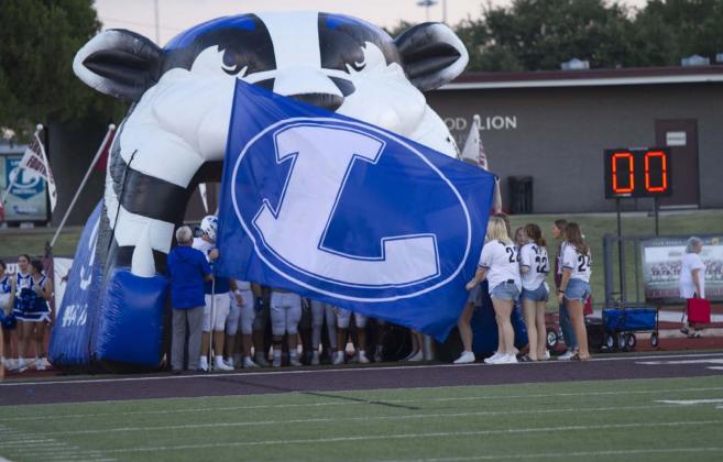 The Lampasas flag flies in front of the team as the Badgers prepare to run out of the tunnel before their week one game against Brownwood last week. HUNTER KING | DISPATCH RECORD