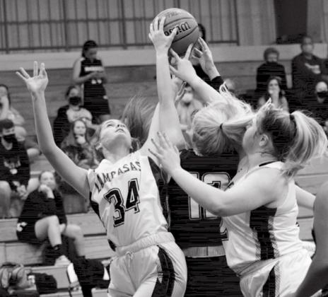 Freshman Jamie Ball (34) and sophomore Morgan Lovejoy go for a rebound. JEFF LOWE | DISPATCH RECORD