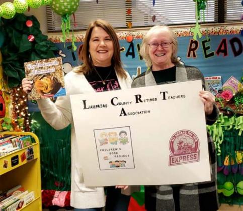 Kline Whitis Elementary School librarian Barbara Moncus, left, holds a copy of the book “Why Do Animals Hibernate?”, which the Lampasas County Retired Teachers Association provided last year to kindergarten students in Lampasas and Lometa schools. Retired teacher Julia Phillips, at right, is soliciting help from other retirees in the area so the book donations can continue in 2021. COURTESY PHOTO