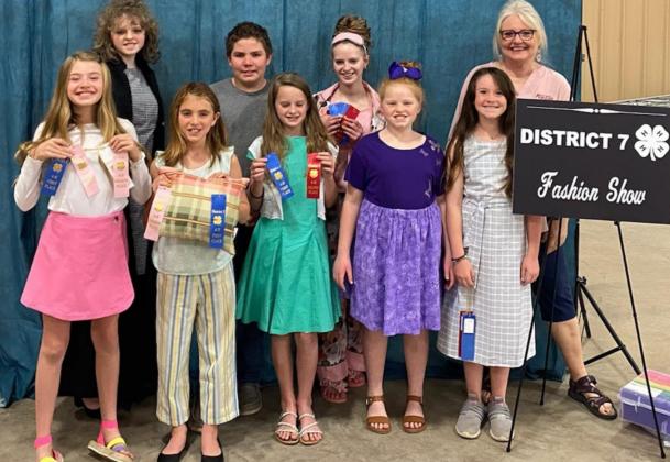 These 4-H members participated recently in the District 7 Fashion Show. Front row, from left, are Emerie Greenberg, Eve Walters, Vivien Martin, Lauren Martin and Rylee McKittrick; back row are Katelyn Martin, David Carr, Allison Martin and Family &amp; Consumer Science Extension Agent Karen DeZarn. COURTESY PHOTO