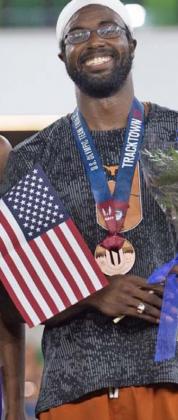 Steffin McCarter is shown with the American flag and his bronze medal at the Olympic Trials in Eugene, Oregon, last weekend. COURTESY PHOTO