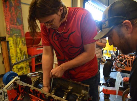 Lampasas High School senior Cohen White, left, and auto tech teacher Edward Gold work to install cam bearings in an LS motor Tuesday afternoon. MONIQUE BRAND | DISPATCH RECORD