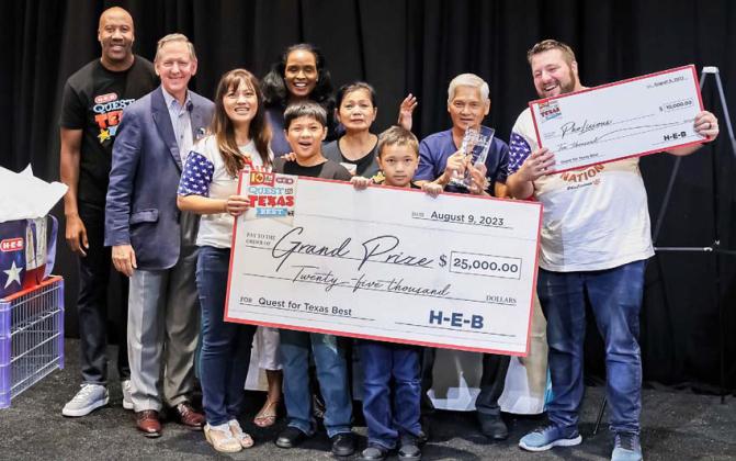 Anh and Joseph Trousdale are shown with family members and H-E-B corporate officials after their PhoLicious soup kits took the grand prize in this year’s Quest for Texas Best competition. courtesy photo