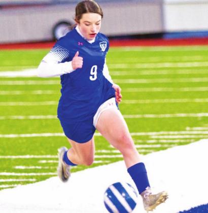Bella Lindsey dribbles down the field during a match in her freshman season. FILE PHOTO