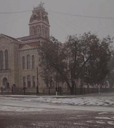 The downtown courthouse square appears to be blanketed in snow after a hail storm Friday. The hail pummeled trees, buildings and vehicles, and left broken limbs and leaves plastered across yards and sidewalks. TERESA THORNTON | DISPATCH RECORD