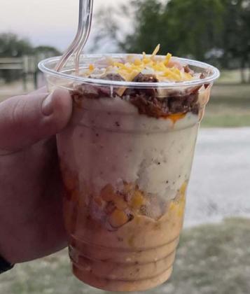 The concession stand served “Cowboy Sundaes,” a brisket treat with queso, mashed potatoes and corn. MASON HINES | DISPATCH RECORD