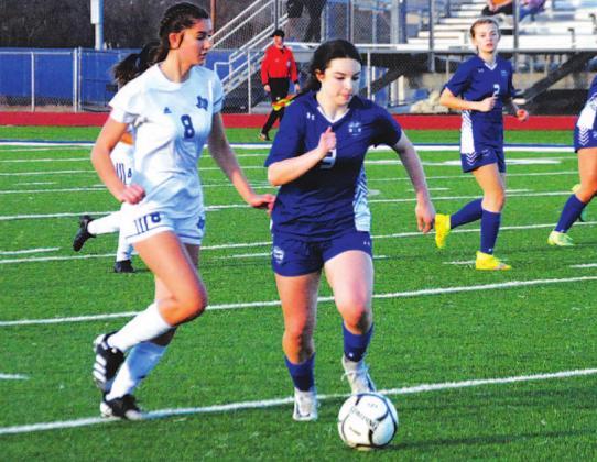 Bella Lindsey dribbles past Jarrell defenders during a district game in the 2022 season, her sophomore campaign. FILE PHOTO
