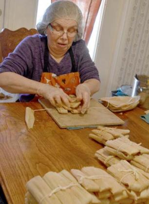 Leonila Gill assembles tamales, which she often makes in batches of 12 dozen at Christmastime. MADELEINE MILLER | DISPATCH RECORD