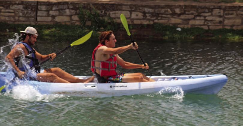 Tate Rainwater and Aden Rascoe paddle like experts in the 2023 Spring Ho Adult Tandem Kayak Race, where they took home the win. AJOYCESARAH MCCABE | DISPATCH RECORD