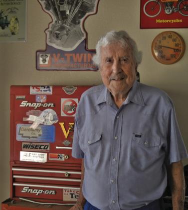 Former motorcycle drag racer Mel Disharoon poses for a photo in front of a toolbox in his garage. Despite being 89 years old, Dishroon stopped riding bikes just three months ago after seven decades on the saddle. ERICK MITCHELL | DISPATCH RECORD