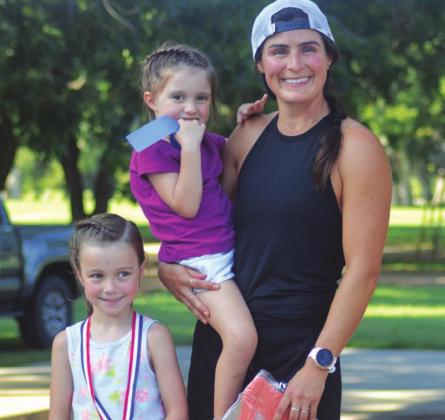 Drea Gibson poses with her children after she was the first female to finish the 10K Saturday. CHARLES WILSON | COURTESY PHOTO