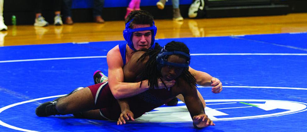 Gabriel Woodfin holds down his opponent at Wednesday’s home wrestling meet. HUNTER KING | DISPATCH RECORD