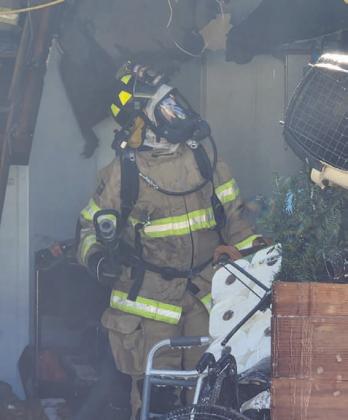 A Kempner firefighter examines the ceiling during fire suppression activities Sunday afternoon. COURTESY PHOTO