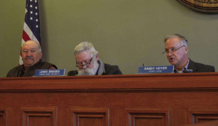 County commissioners Mark Rainwater, at left, and Lewis Bridges listen as County Judge Randy Hoyer asks questions during Monday’s meeting. ERICK MITCHELL | DISPATCH RECORD