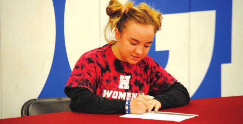 Brianna Miller signs her letter of intent to wrestle for Hastings College in Nebraska. HUNTER KING | DISPATCH RECORD