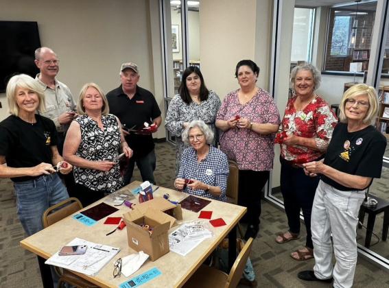 Members of The Stars at Night committee are preparing flashlights for distribution to children at Saturday evening’s event. COURTESY PHOTO