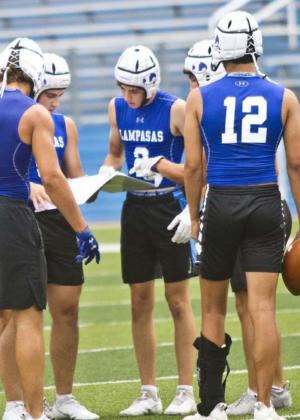 Badger players, left to right, Aden Rascoe, Dax Brookreson, Owen Stubbs, Ethan Moreno and Dylan Sanchez look at plays in the huddle at a 7-on-7 game last week in Georgetown. JEFF LOWE | DISPATCH RECORD e, Dax Brookreson,