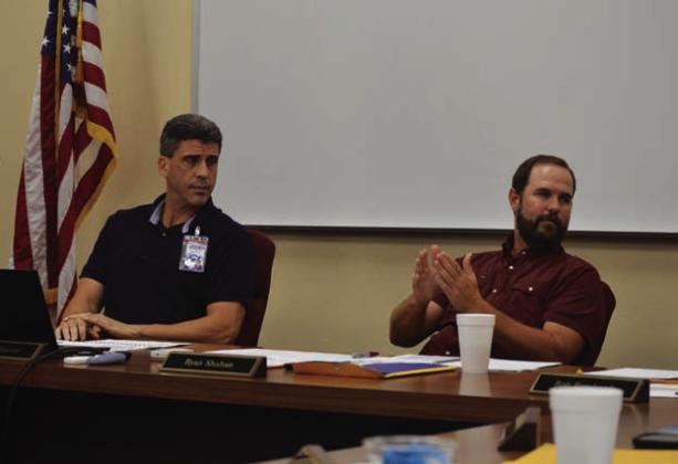 Lampasas Independent School District Superintendent Dr. Chane Rascoe (left) and Board President Ryan Shahan discuss the future middle school campus’ square footage during Monday’s meeting. ERICK MITCHELL | DISPATCH RECORD