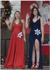 ERICK MITCHELL | DISPATCH RECORD Kara Burnett, at left, and Brittany Martinez wave to the crowd. Martinez was crowned the high school Snow Queen, while Burnett earned the title of Princess.