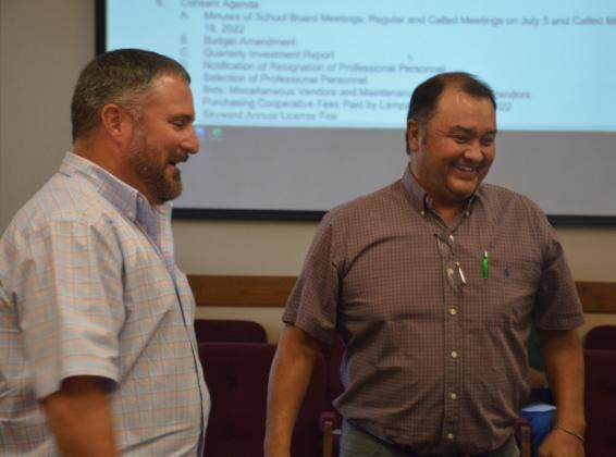 Harvey Stinnett, right, and Jeff Rutland share a laugh after a swearing-in ceremony during Monday’s regular meeting of the school board. Stinnett is new to the board, and Rutland was uncontested for re-election to his trustee position.MONIQUE BRAND | DISPATCH RECORD