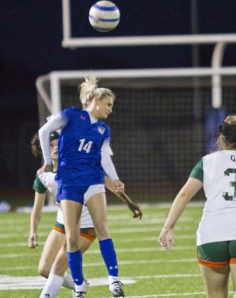 Tatum Linney (14) heads the ball in Tuesday’s home match. JEFF LOWE | DISPATCH RECORD