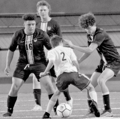 Joseph Whitehead (16), Nate Abken (back-center) and Cody Hinson (far right) defend against Wimberley in a soccer scrimmage at home on Friday. JEFF LOWE | DISPATCH RECORD