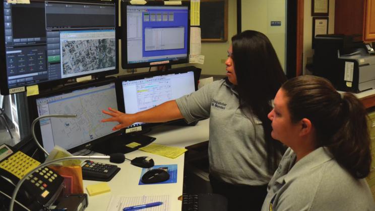 Lampasas Police Department communications personnel Mary Mendez, left, and Danicka Keeling look over maps and data relating to 911 calls. Some of the equipment pictured will be replaced as the police department updates its communications equipment. FILE PHOTO