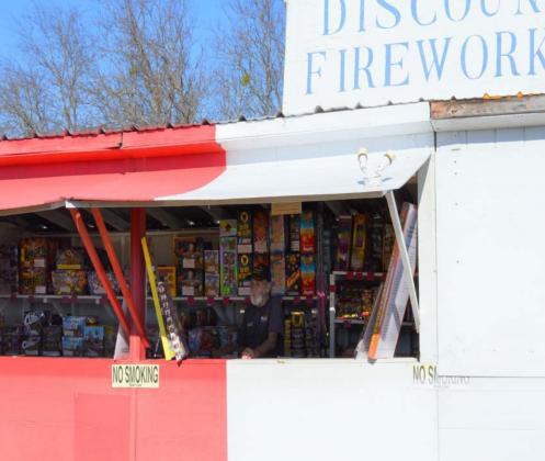Bob Stewart, owner of Bob’s Discount Fireworks, looks on from inside his stand as he awaits patrons this week. MASON HINES | DISPATCH RECORD