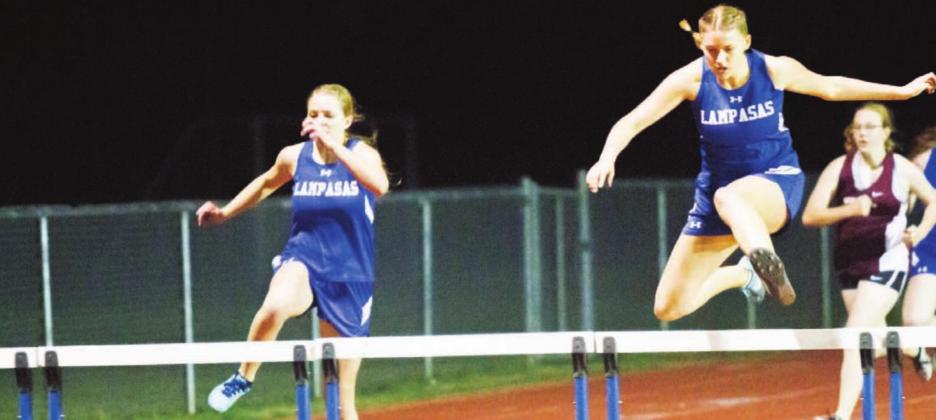 Delanie Smith, right, won the JV girls’ 300-meter hurdles last week at the Johnny “Lam” Jones Relays. Sarah Rouss, left, placed second in this race and won gold in high jump. JEFF LOWE | DISPATCH RECORD