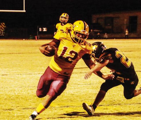 Emmanuel Prado (12) runs the ball after catching a pass during Friday’s win. MEGAN LUSTY | COURTESY PHOTO