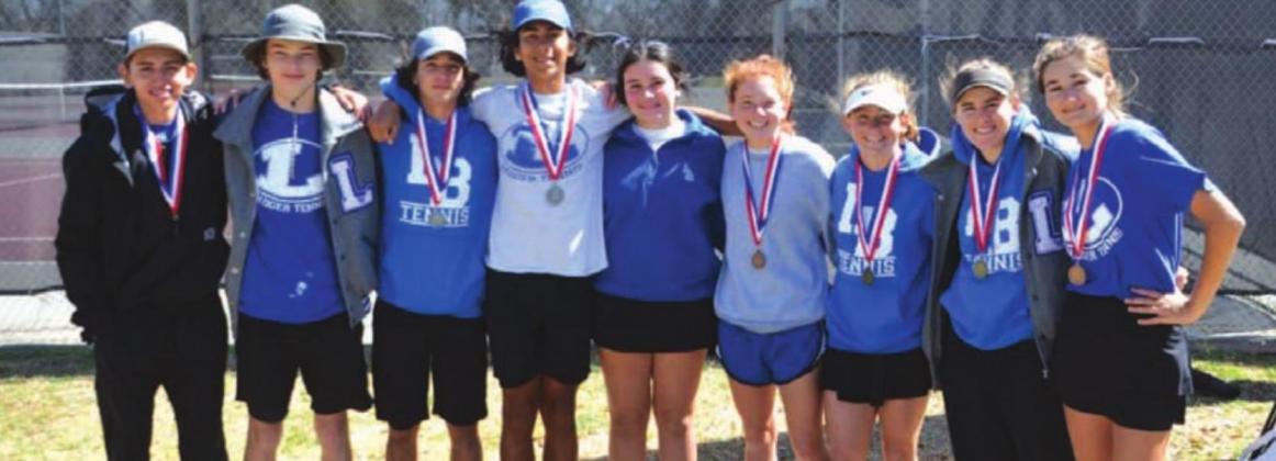 The tennis players pose for a photo with their medals after competing at district. COURTESY PHOTO