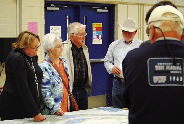 The Texas Department of Transportation offered maps at a recent public meeting showing various options for a possible route around the downtown Lampasas area that could help relieve traffic through the center portion of town. Shown here reviewing the proposals are, from left, Jani Edwards, Wanda Lang, Roland Lang and Mickey Edwards. The deadline to offer input on the relief route alternatives is Dec. 9. HUNTER KING | DISPATCH RECORD